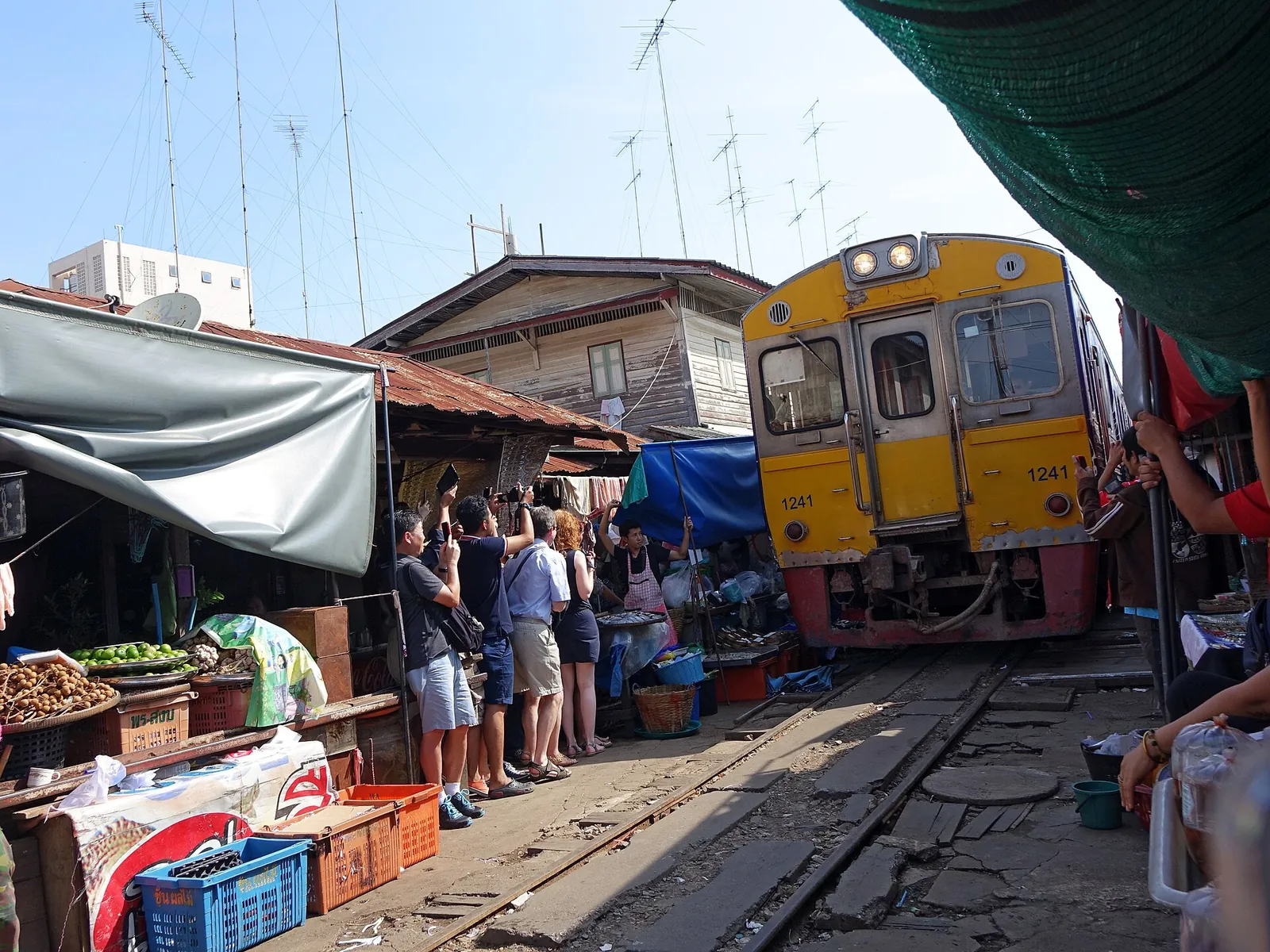 Train on the tracks through Maeklong Railway Market